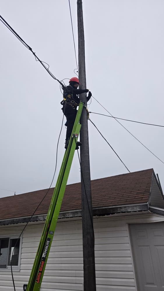 Technician completing aerial line work
